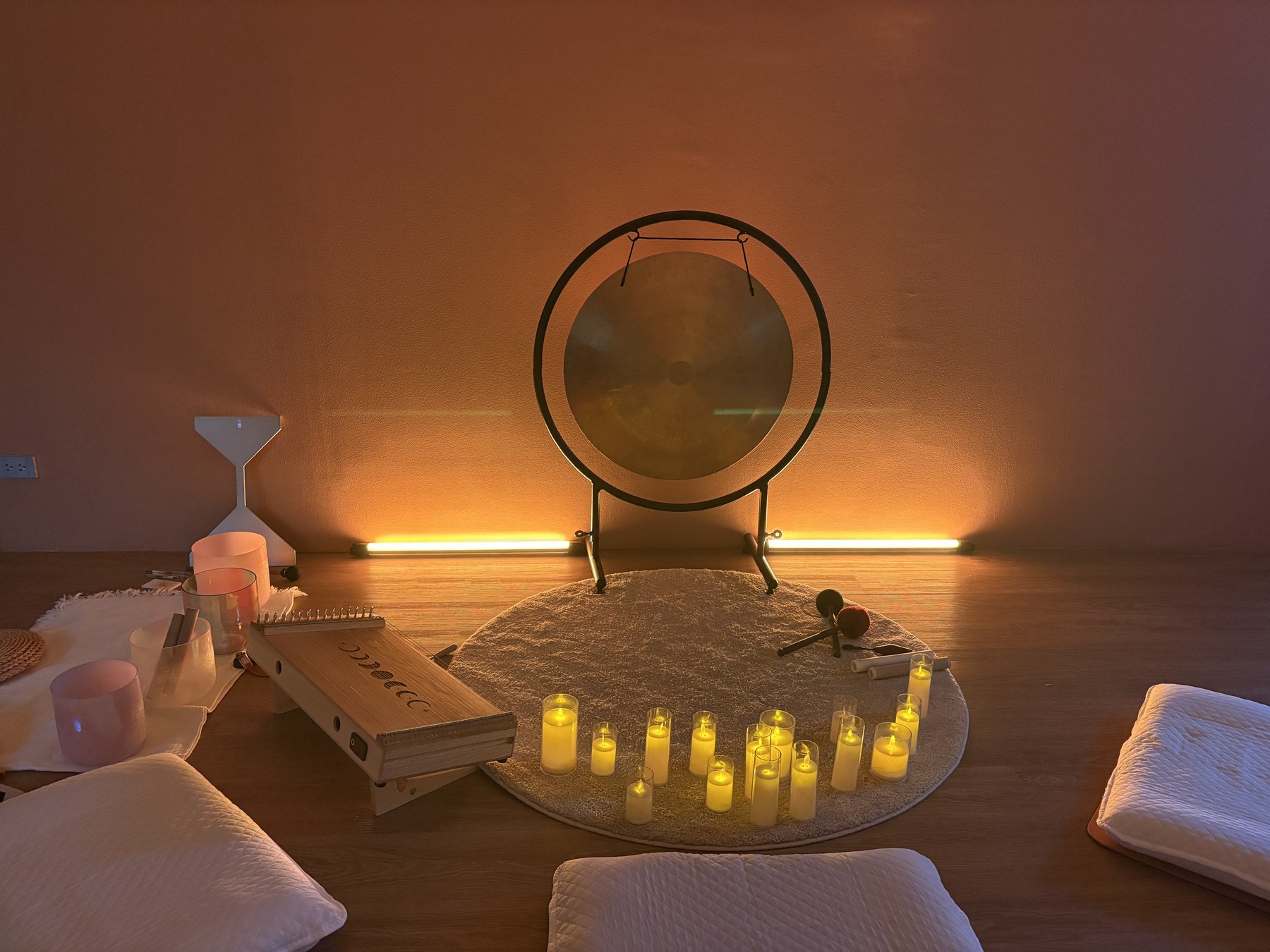 Gong and candles in a warm studio setting