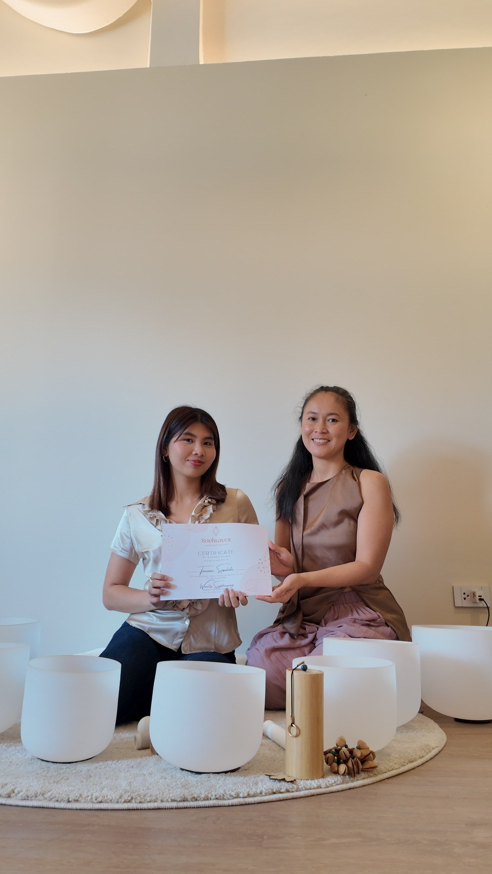 Student receiving a sound healing training certificate