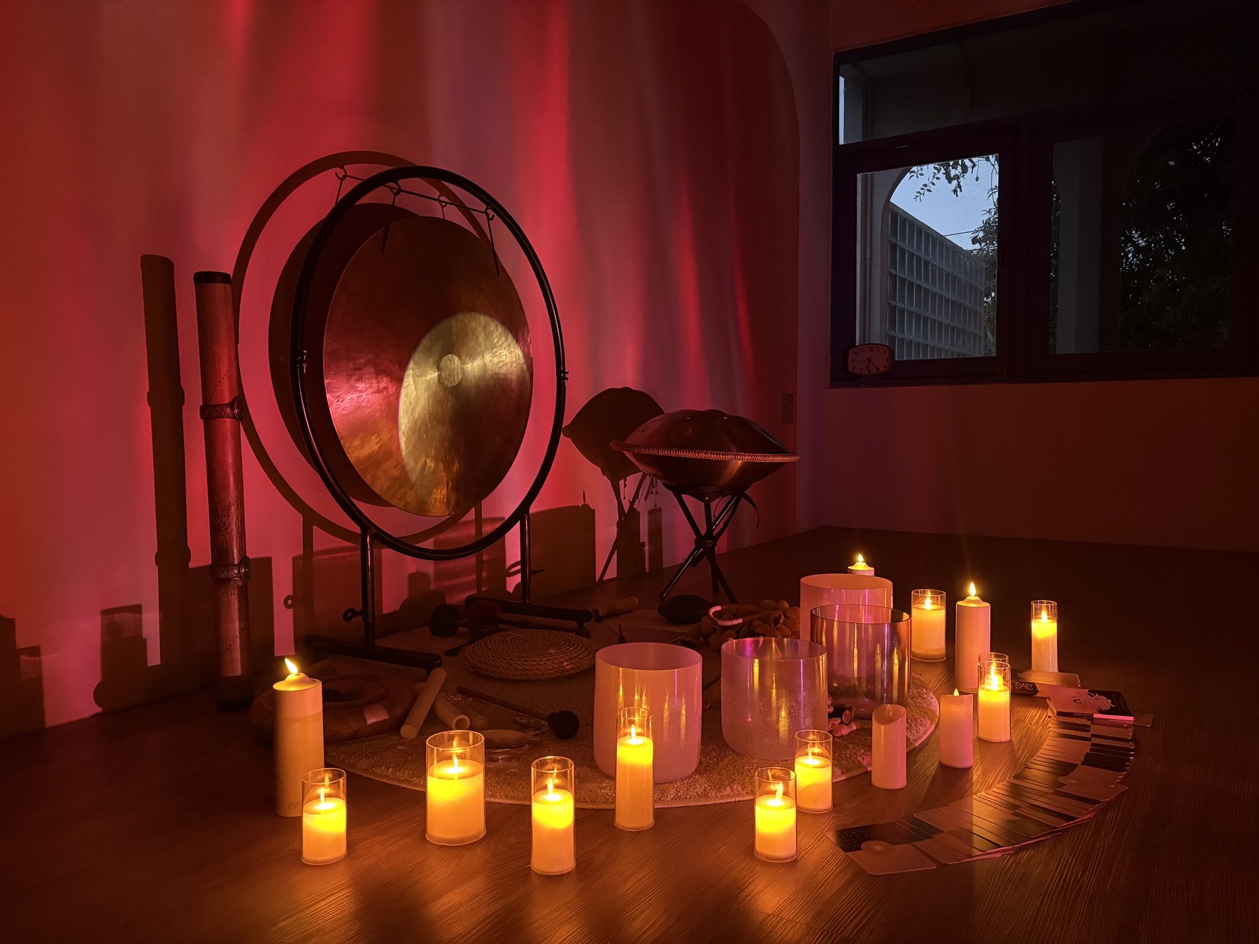 Red-lit gong surrounded by candles in the Soulwaves studio